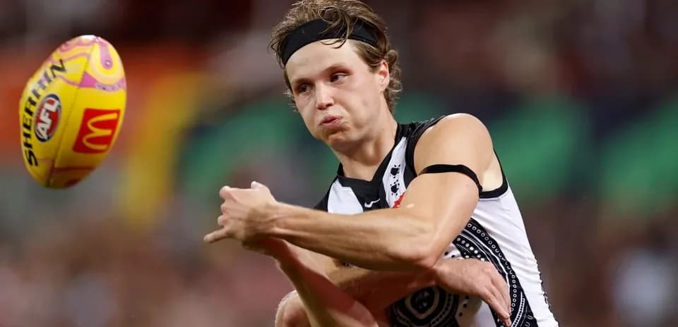 Player passing the ball during an AFL match