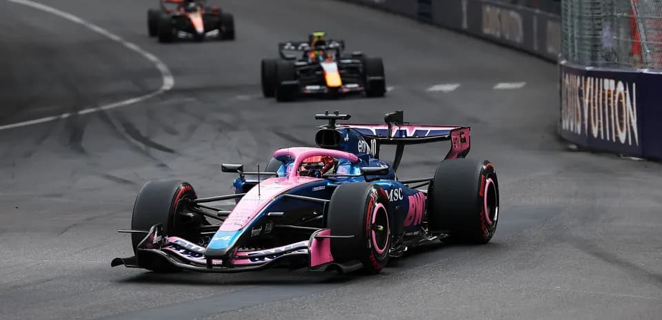 Formula 1 car racing around a track corner