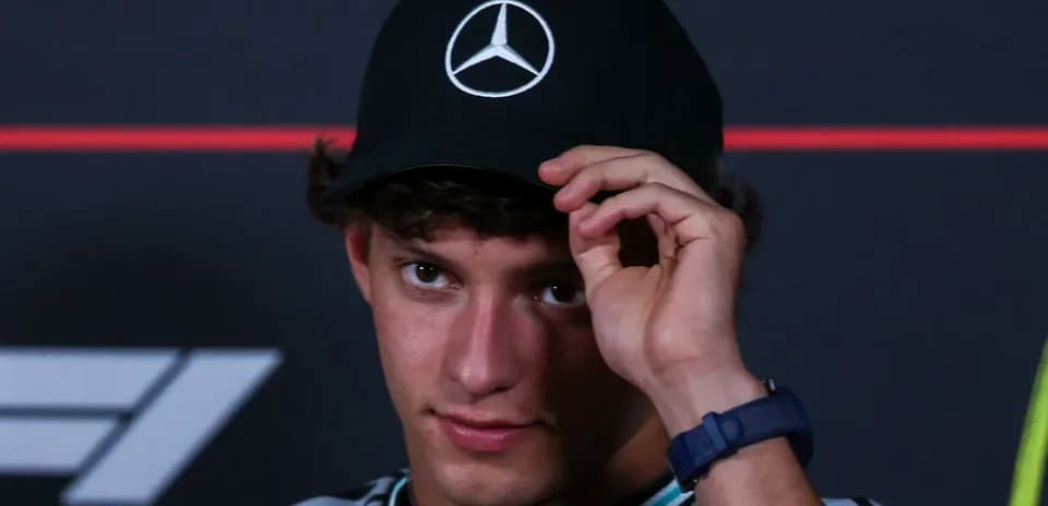 Young man adjusting cap during press conference