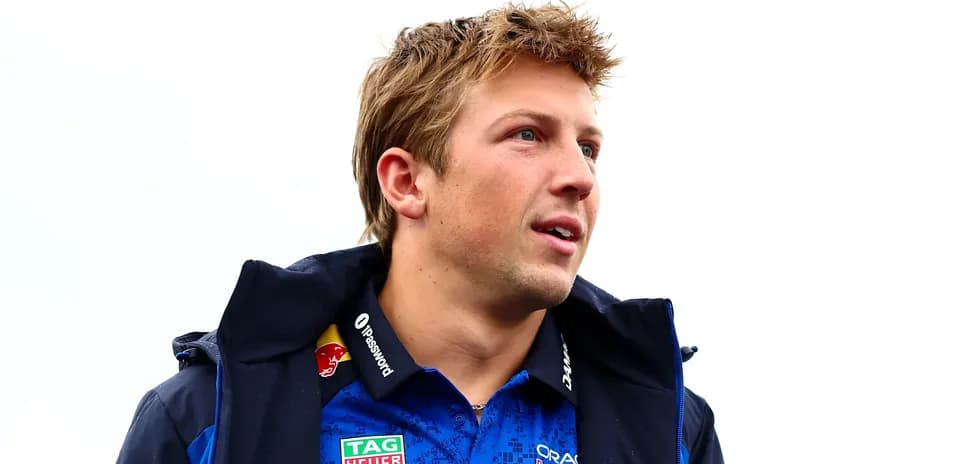Driver wearing team jacket and polo shirt