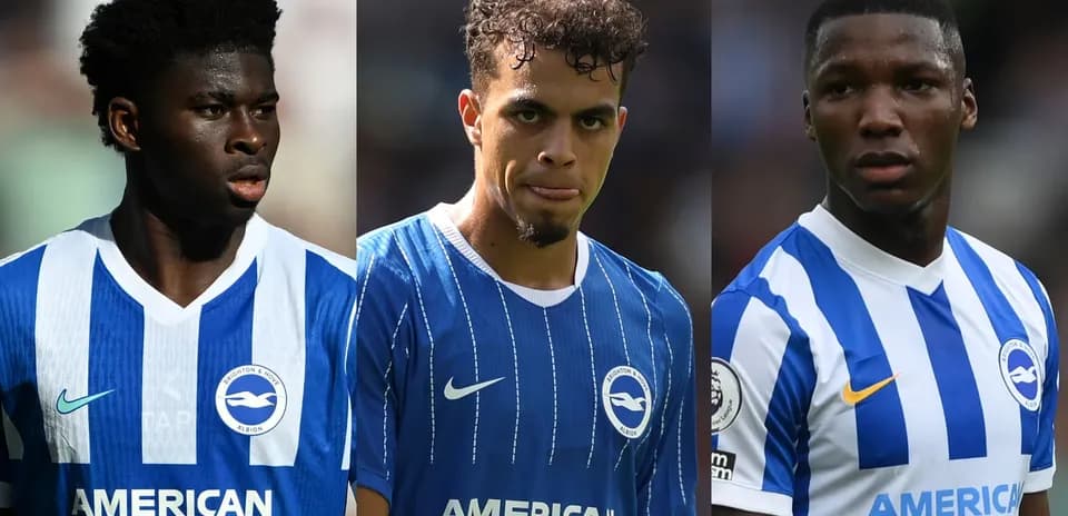 Three Brighton players in blue kits on pitch