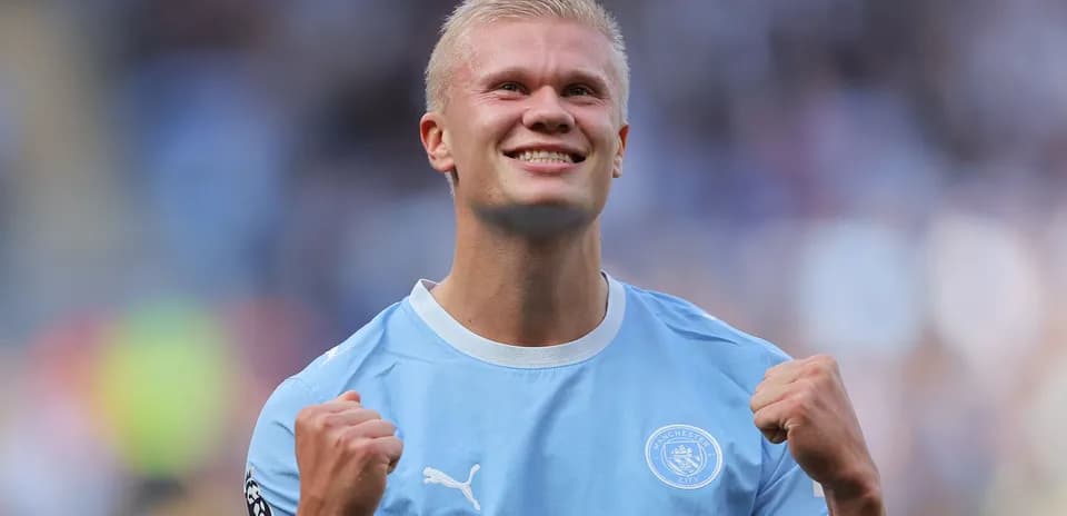Player celebrating victory in Manchester City jersey