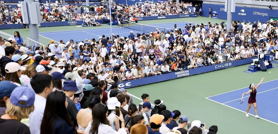 Crowd watching a tennis match at a stadium