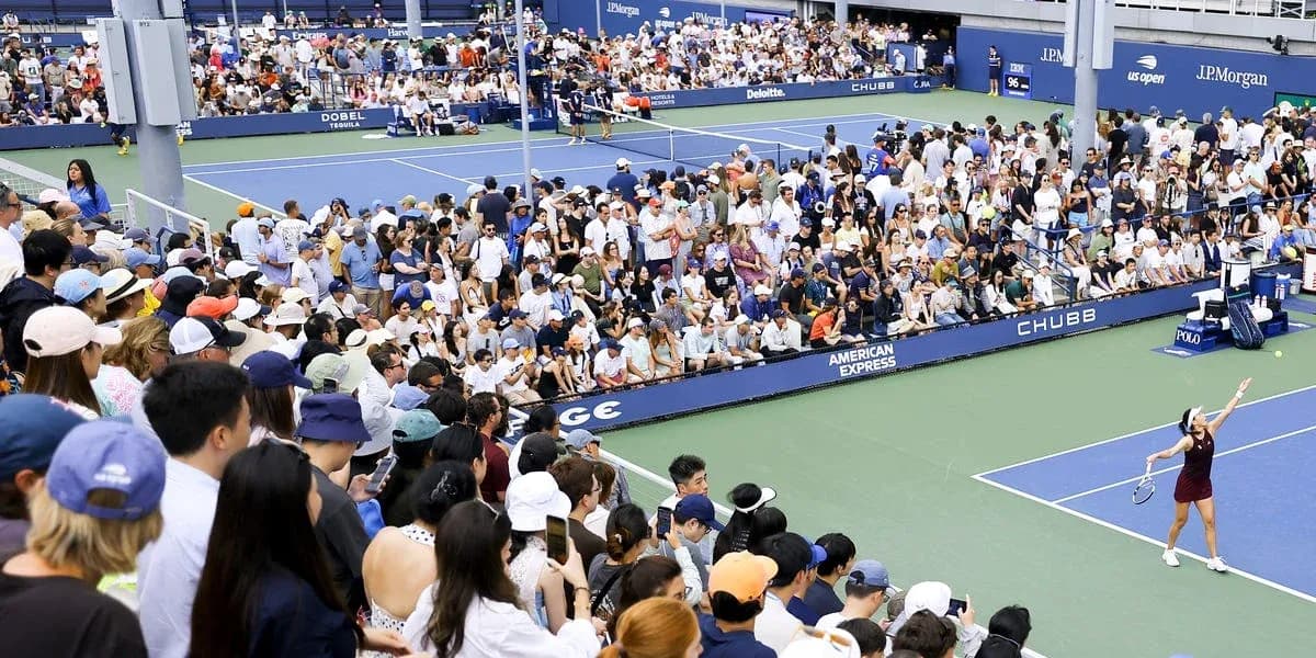 Crowd watching a tennis match at a stadium