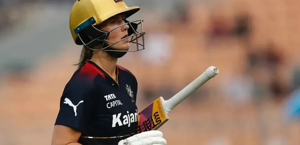 Cricketer wearing helmet and holding bat