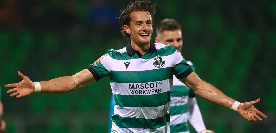 Player celebrating goal with arms outstretched