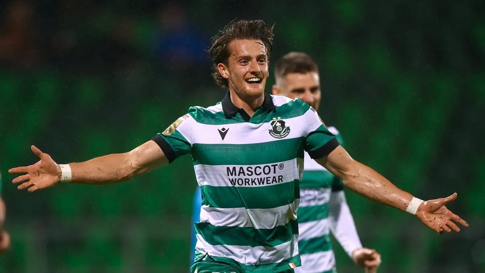 Player celebrating goal with arms outstretched