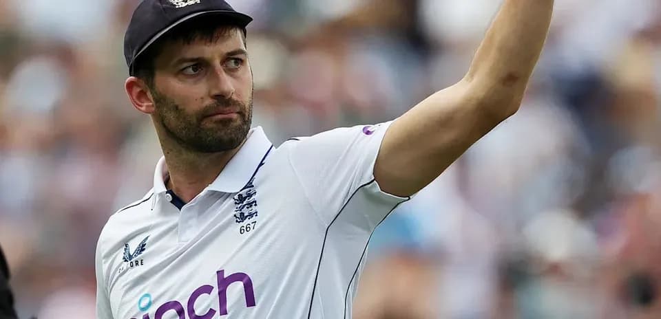 Cricketer gesturing during match in England kit