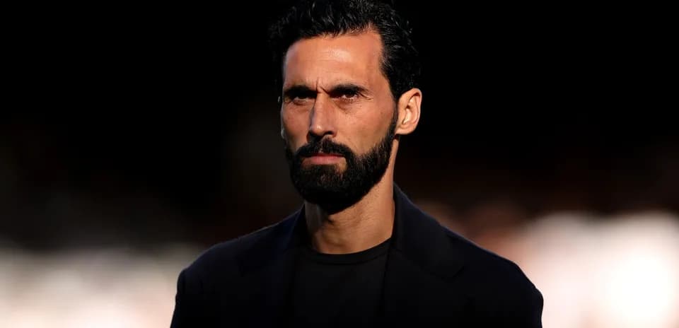 Man with beard looking serious against dark background