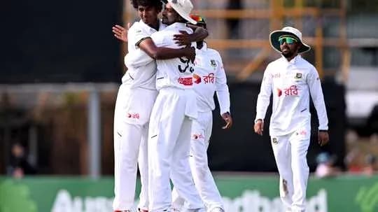 Players celebrating after taking a wicket in cricket match