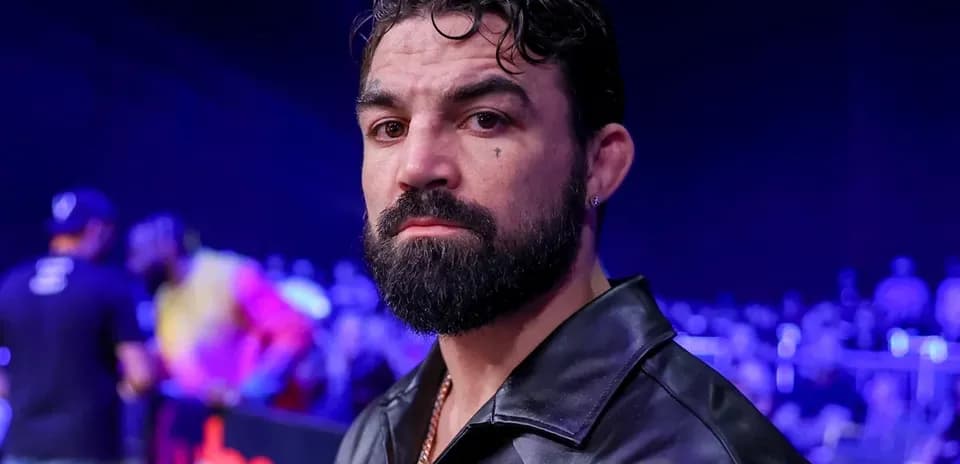Man with beard in a dark jacket at event