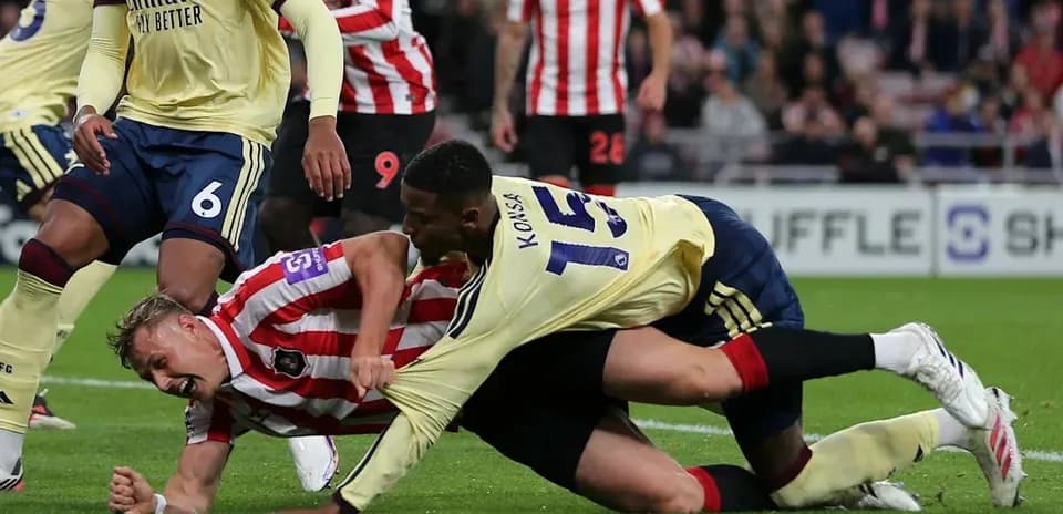 Player tackling opponent during football match