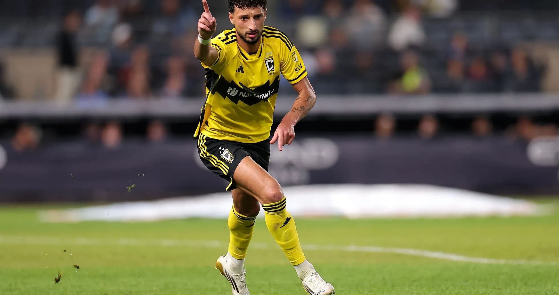 Player in yellow jersey celebrating on the field