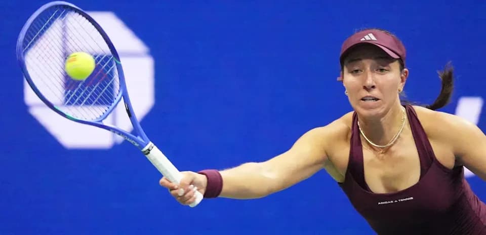 Tennis player reaching for a ball with racket