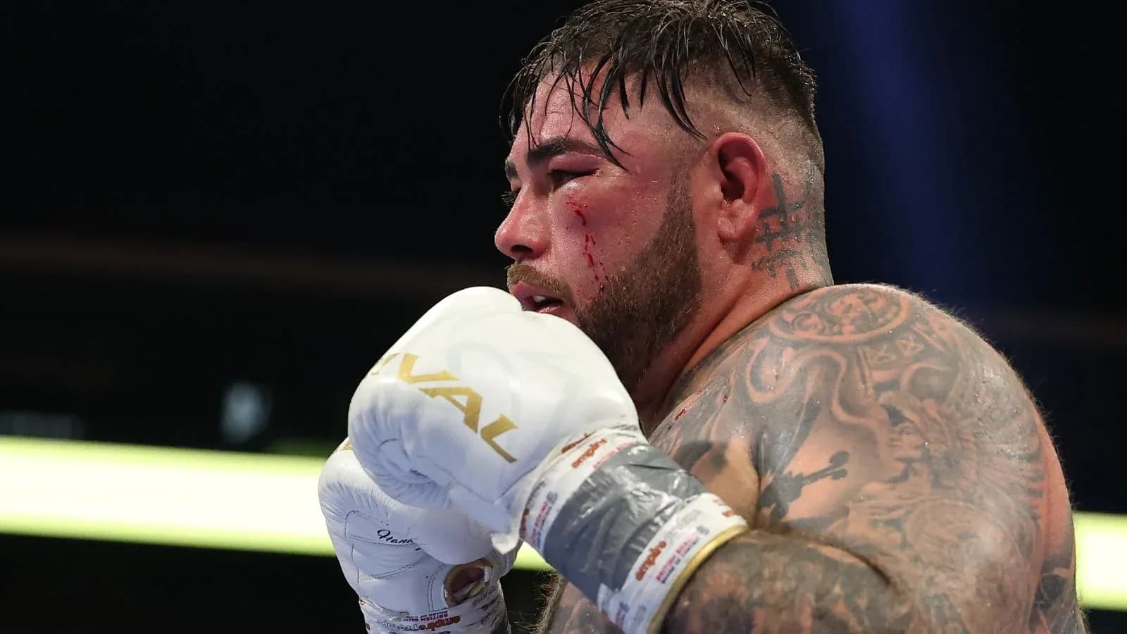 Boxer with blood on face during match