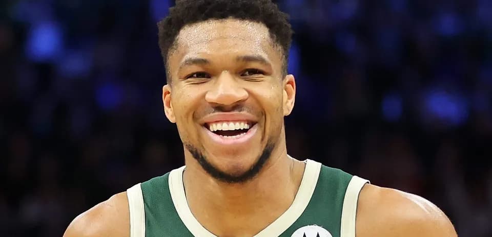 Player smiling in Milwaukee Bucks uniform