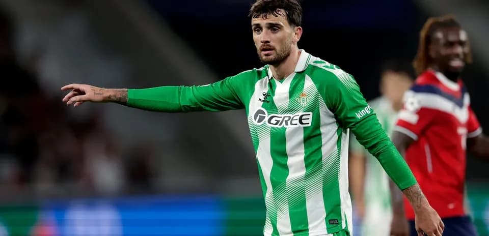 Player in green and white jersey gesturing on field