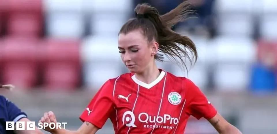 Player in red jersey dribbling the ball during match