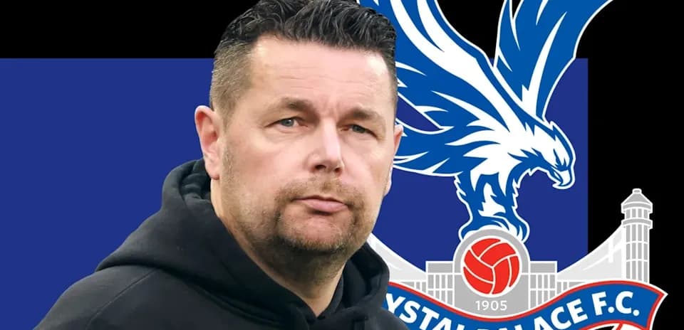 Coach with Crystal Palace FC logo in background