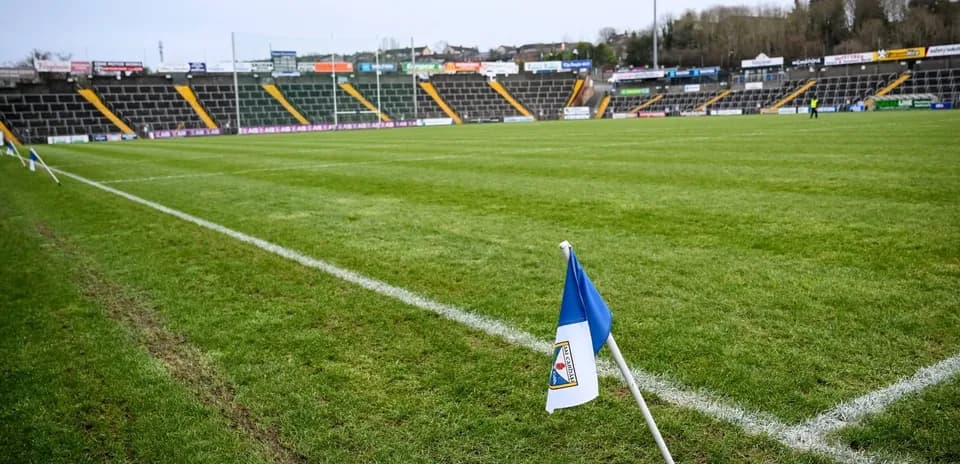 Corner flag on a rugby pitch with empty stands