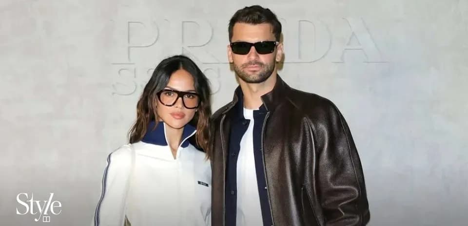 Couple posing at Prada event in stylish outfits