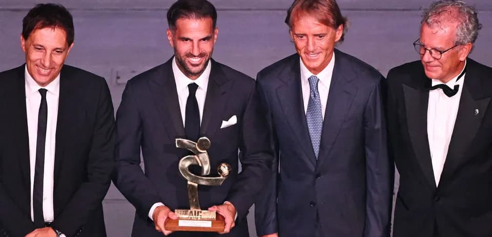 Four men at award ceremony holding trophy