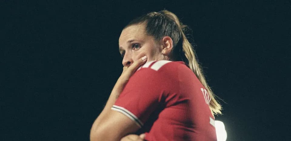 Player in red jersey looking concerned on field
