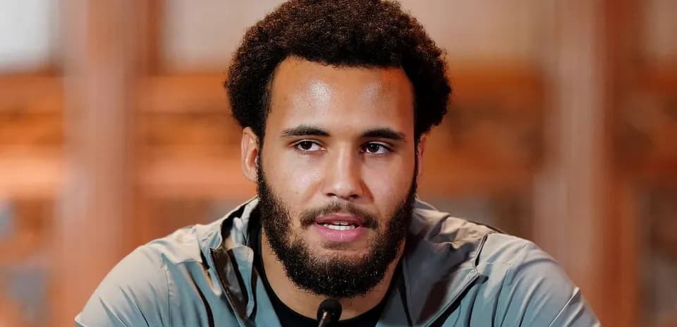 Athlete speaking at press conference with microphone