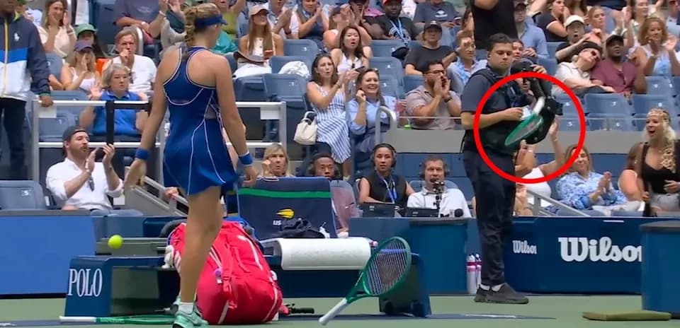 Tennis player preparing to serve with crowd applauding
