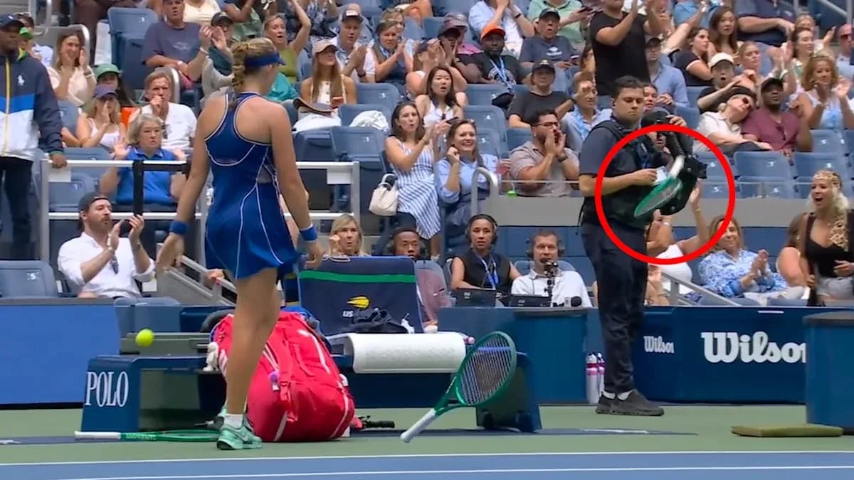 Tennis player preparing to serve with crowd applauding
