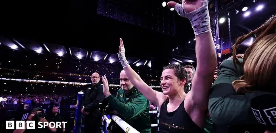Female boxer celebrating with raised hands after match