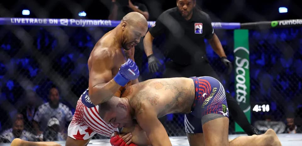 Fighters grappling in the octagon during match