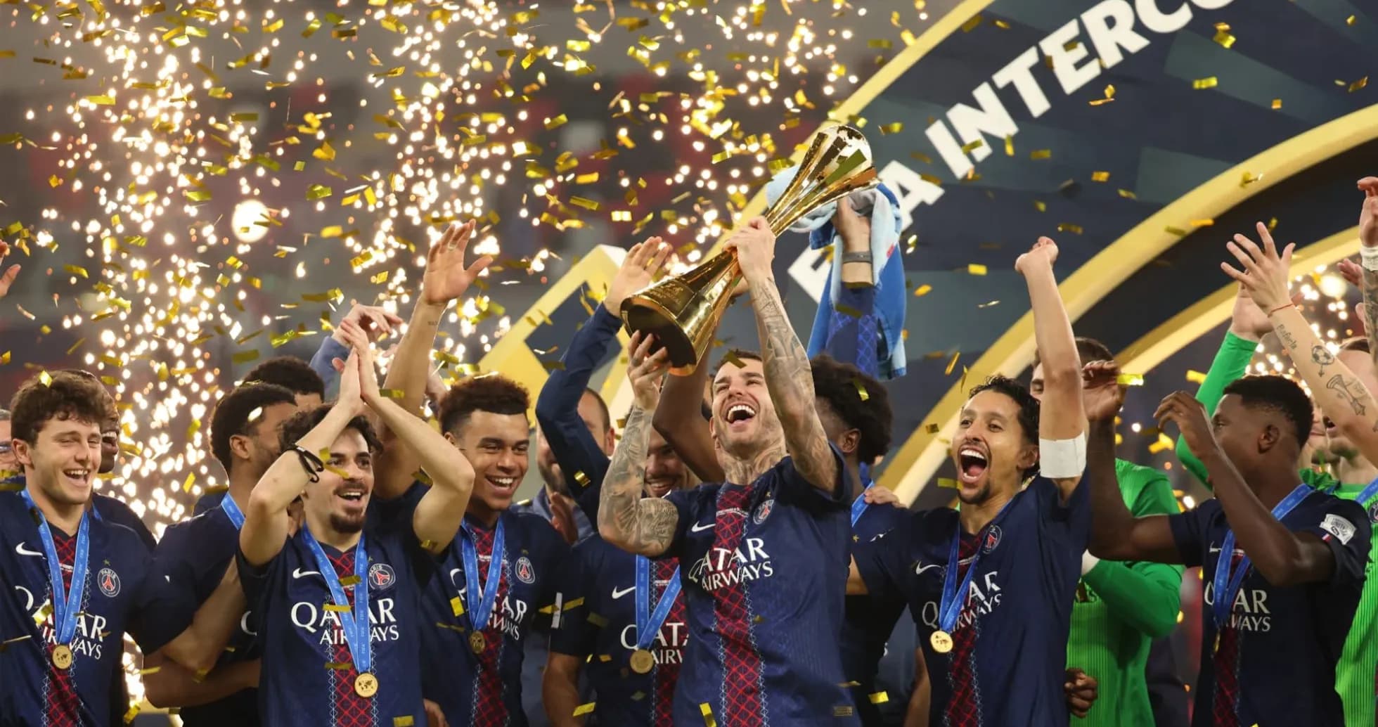 PSG players celebrating with trophy and confetti