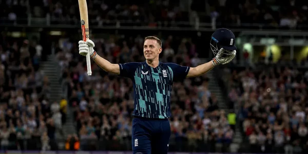 Cricketer celebrating with bat and helmet raised