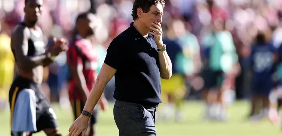 Coach walking on field after match conclusion