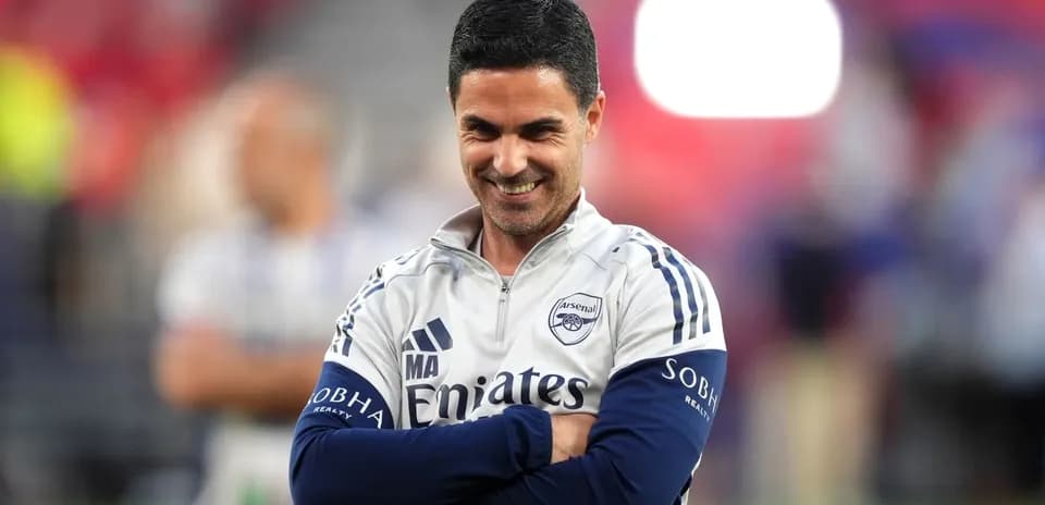 Arsenal manager smiling during a training session
