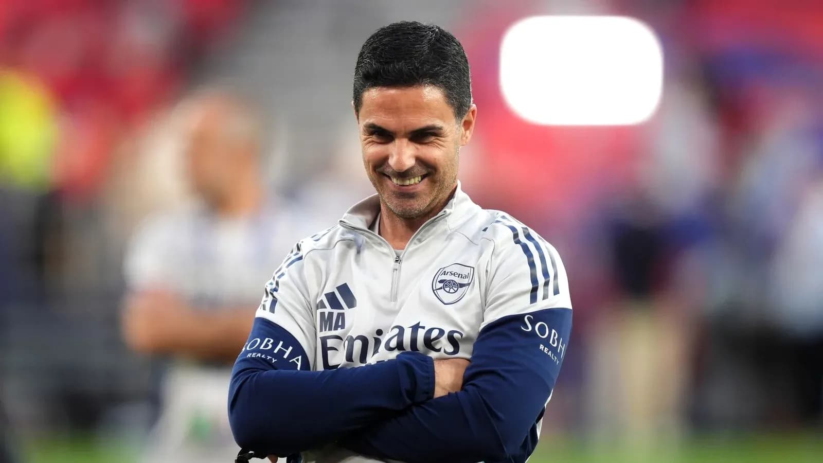 Arsenal manager smiling during a training session