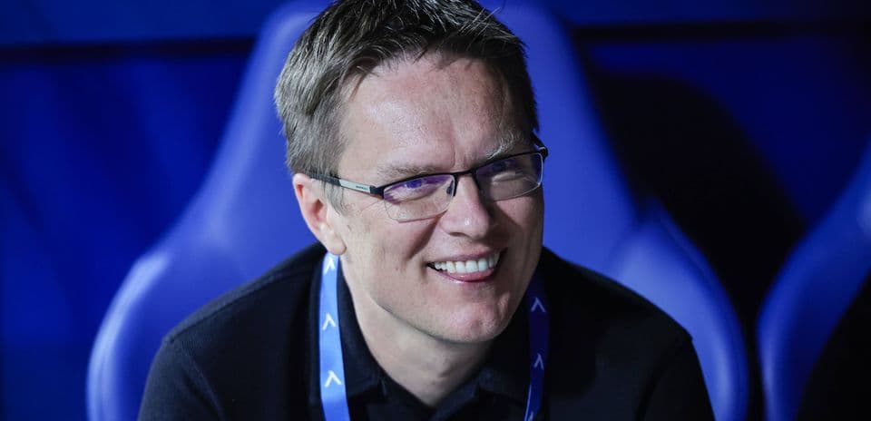 Person smiling in a sports venue seat