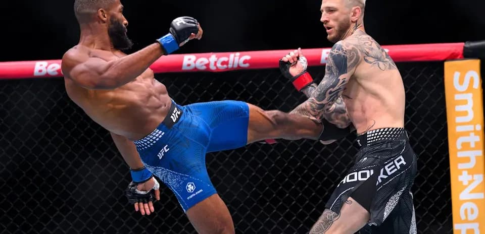 Two fighters engaged in a kick during match