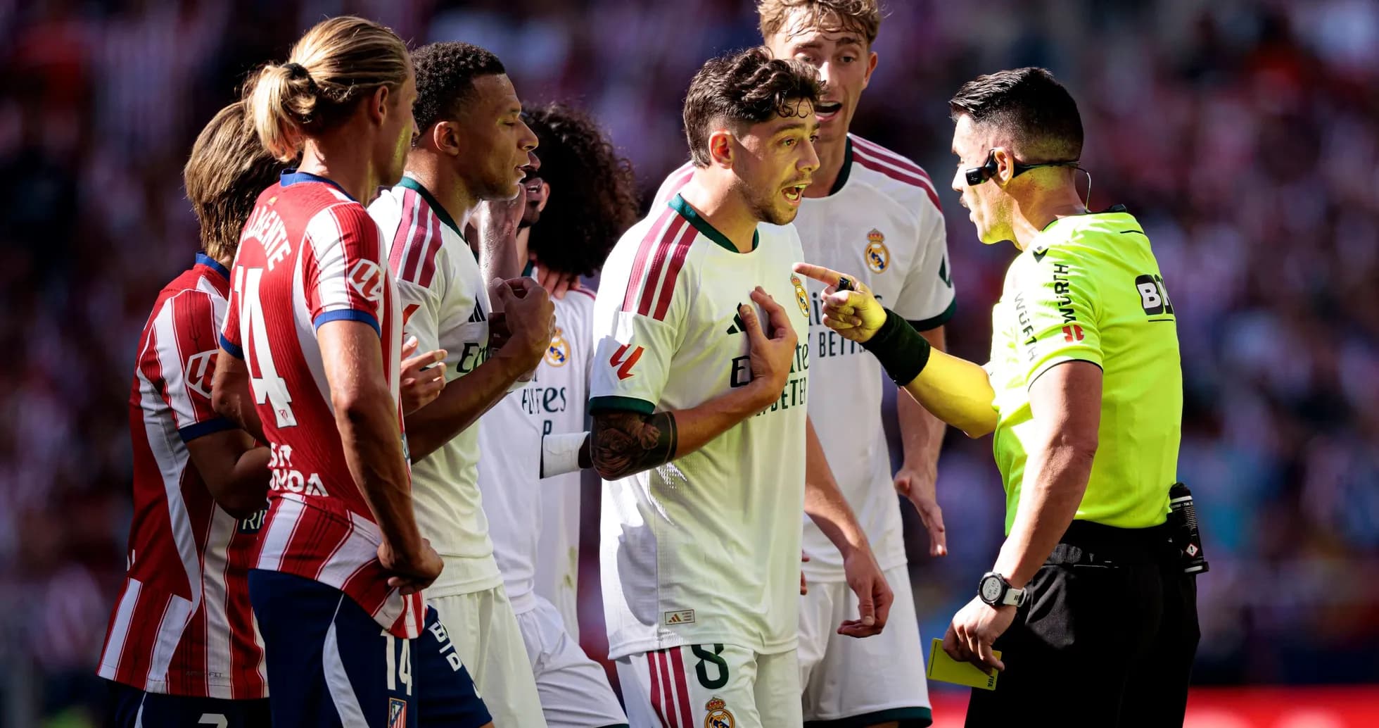 Players arguing with referee during a match