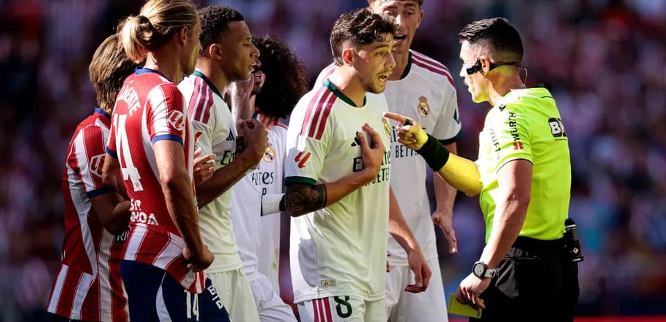 Players arguing with referee during a match