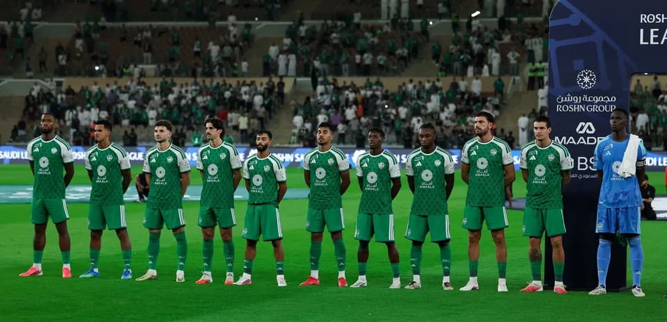 Football team lined up before match in green uniforms
