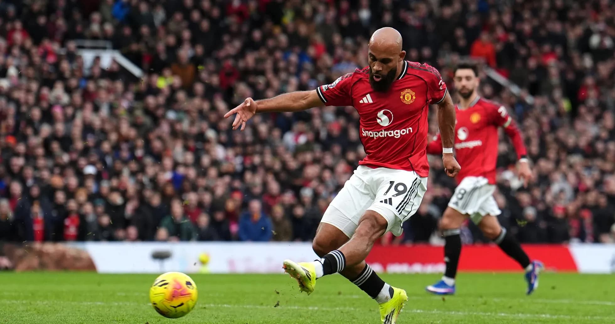 Player taking a shot during Manchester derby
