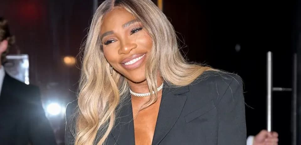 Smiling woman in a black blazer at event