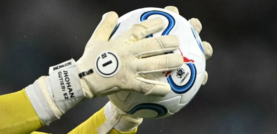 Goalkeeper catching a soccer ball during match