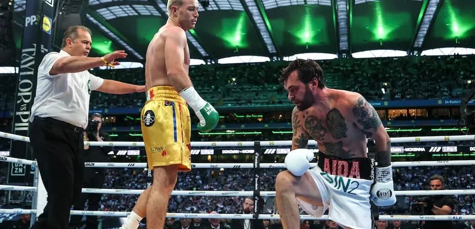 Boxers in the ring during a match with referee