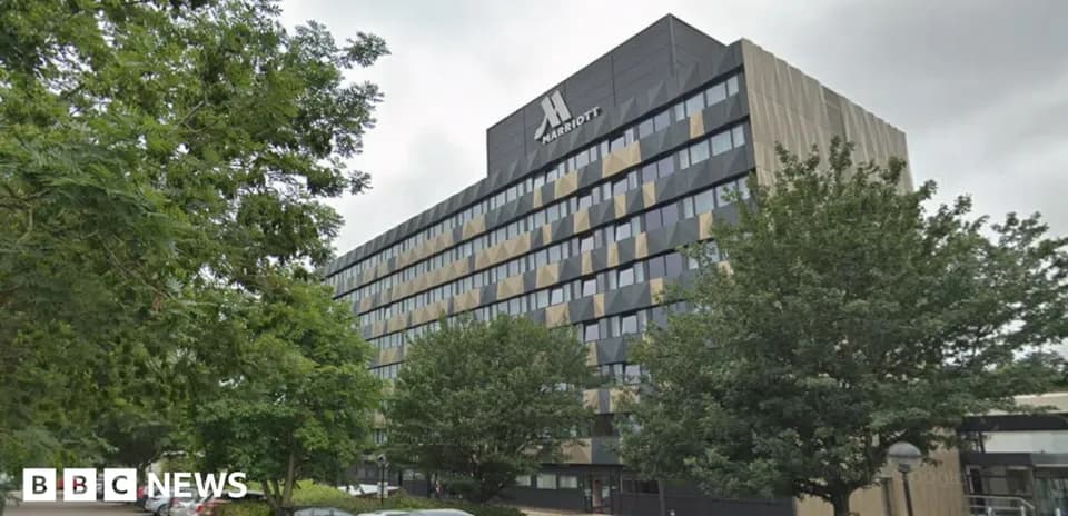 Marriott hotel building surrounded by trees and parking