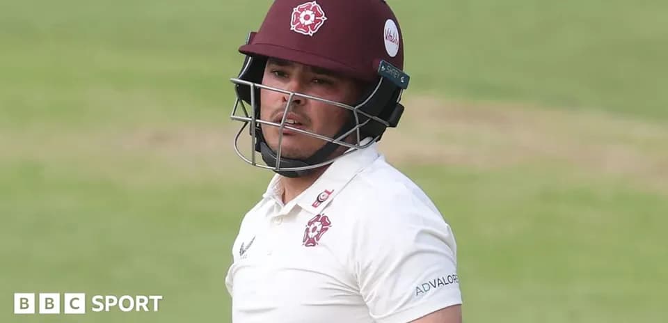 Cricketer wearing helmet during match at the crease