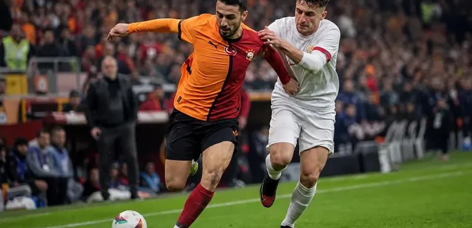 Player in orange shirt being challenged by opponent