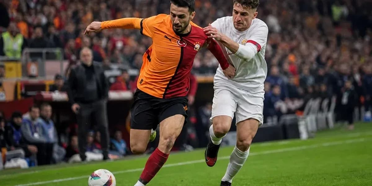 Player in orange shirt being challenged by opponent